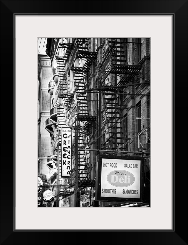 Black and white photo of several fire escapes on the sides of buildings in Manhattan.