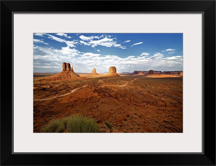 Large rock formations in the desert landscape of Monument Valley.