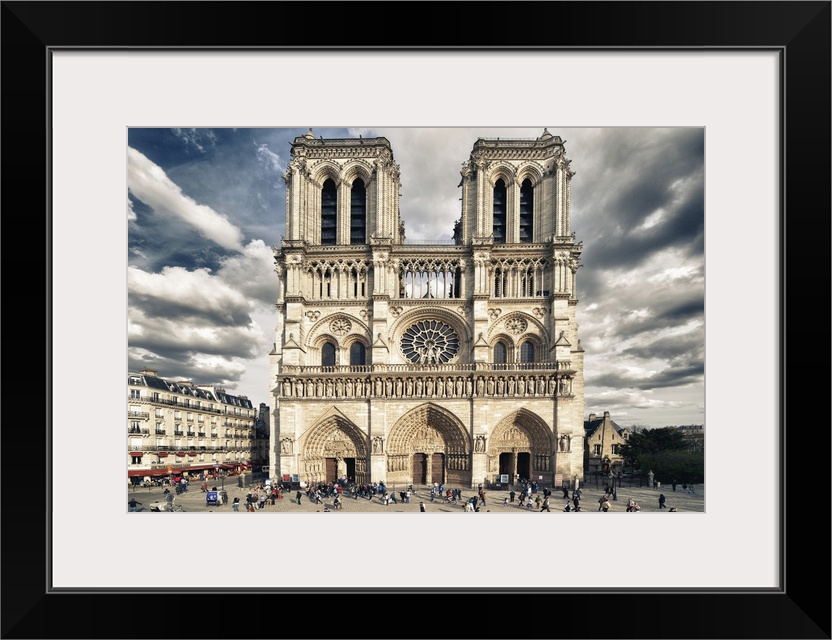 Fine art photograph of the front of the Notre Dame of Paris Cathedral with a vivid sky.