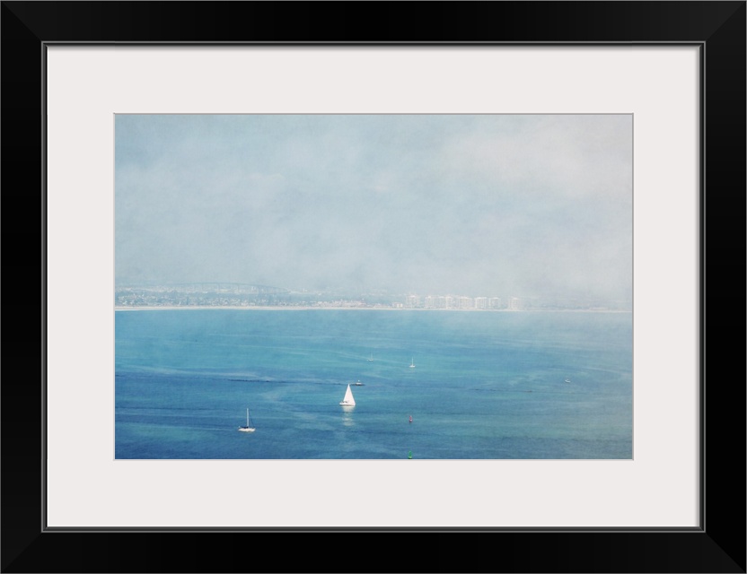 White sailboats on the deep blue ocean off the coast of Coronado, California.