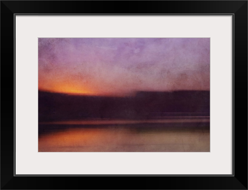 Photograph of a cove surrounded by silhouetted land forms with a sunset illuminating the sky in purple.