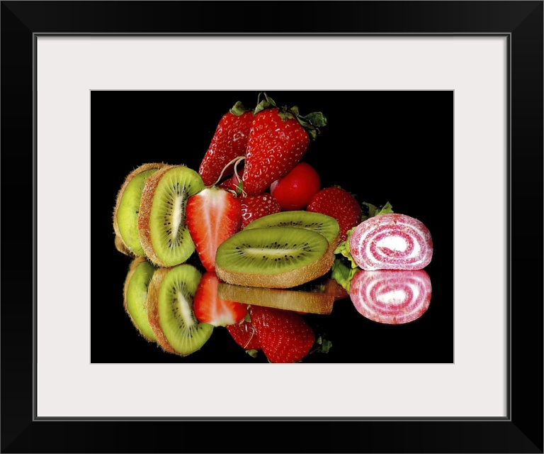 Kiwis, strawberries, and candy on a mirror.