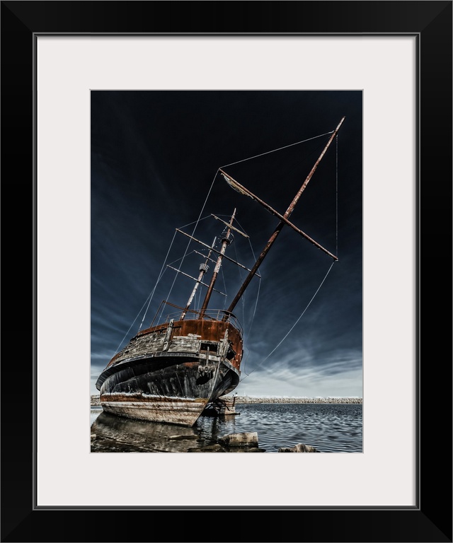 Rusty old ship on the shore of Lake Ontario.