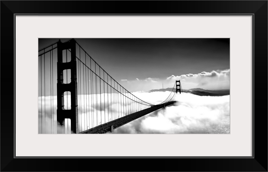 Black and white image of the Golden Gate Bridge in San Francisco rising above the clouds.