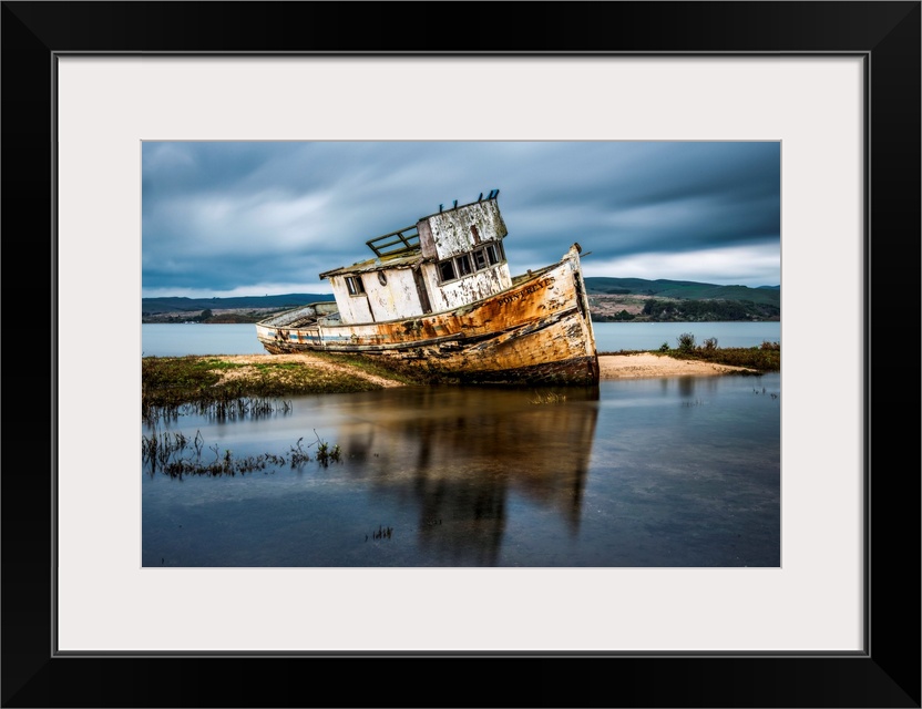 Abandoned and ruined ship beached in shallow water at Inverness, California.