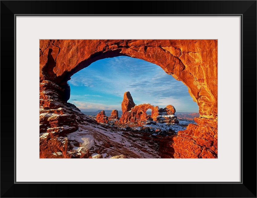 Turret Arch stands as an anomaly in the petrified dune field as seen through the North Window Arch in Winter, Arches Natio...