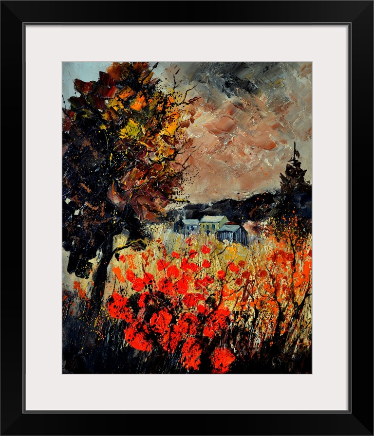 An autumn scene of red blooming flowers in a field near a small village.