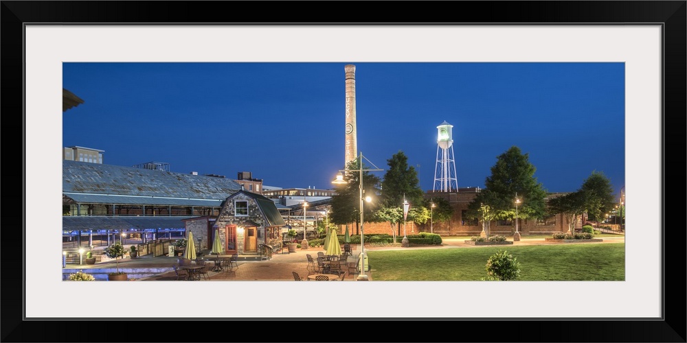 Lucky Strike Water Tower and Smokestack over the brick factory buildings at night, American Tobacco Historic District, Dur...