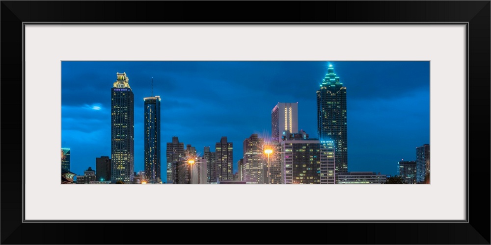 Skyscrapers in Atlanta, Georgia, illuminated at night against a deep blue sky.