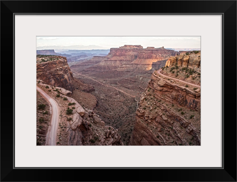 View of the rocky desert landscape with mesas in the distance, seen from Shafer Trail in Canyonlands National Park, Moab, ...