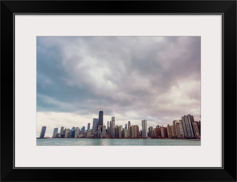 Photo of Chicago's skyline under dramatic clouds.