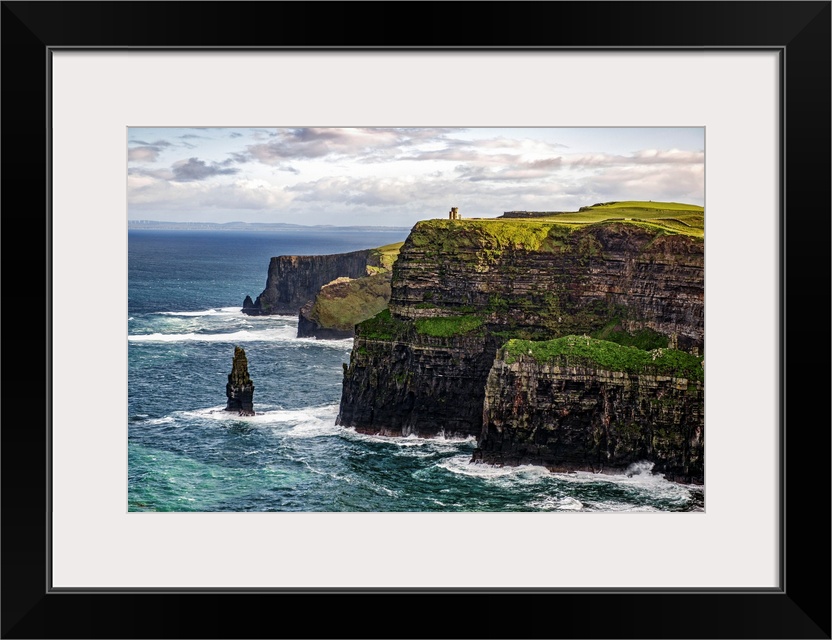 Photograph of the Cliffs of Moher with O'Brien's Tower seen in the distance, marking the highest point of the Cliffs of Mo...