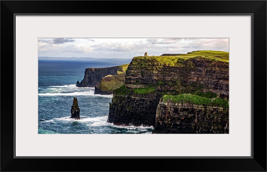 Panoramic photograph of the Cliffs of Moher with O'Brien's Tower seen in the distance, marking the highest point of the Cl...