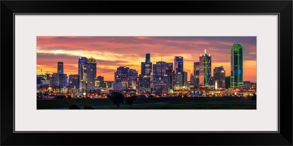 A horizontal image of the Dallas, Texas city skyline with a brilliant sunset.