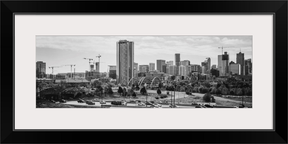 Photograph of the Denver, Colorado skyline with cloudy skies above.