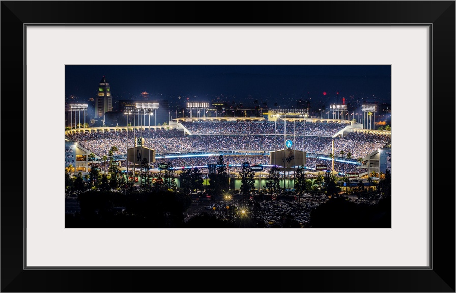 Panoramic photograph of Dodger Stadium lit up on a game night.