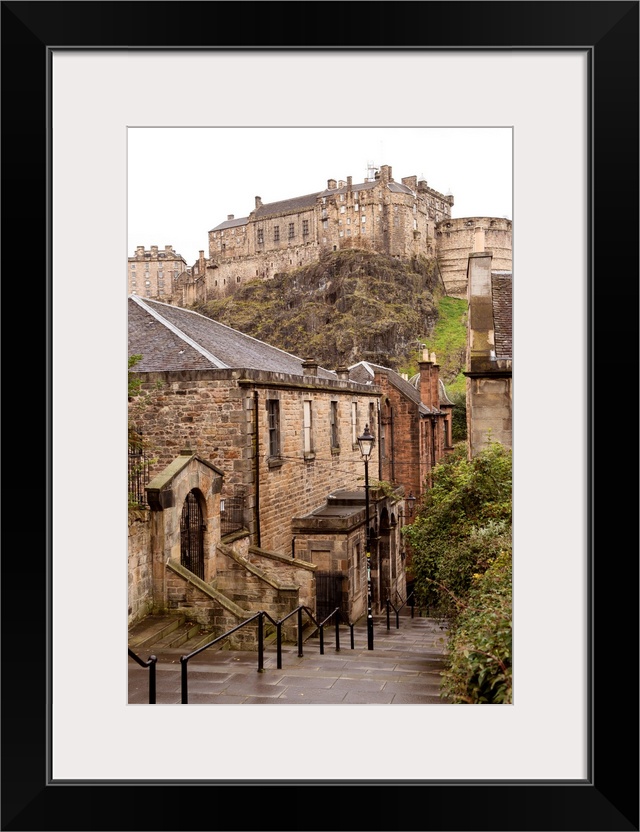 Photograph of Edinburgh Castle with cobblestone buildings in the foreground.