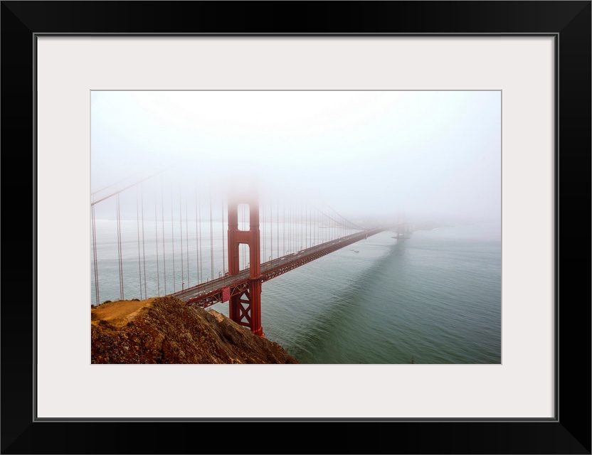 Landscape photograph of fog taking over the Golden Gate Bridge.