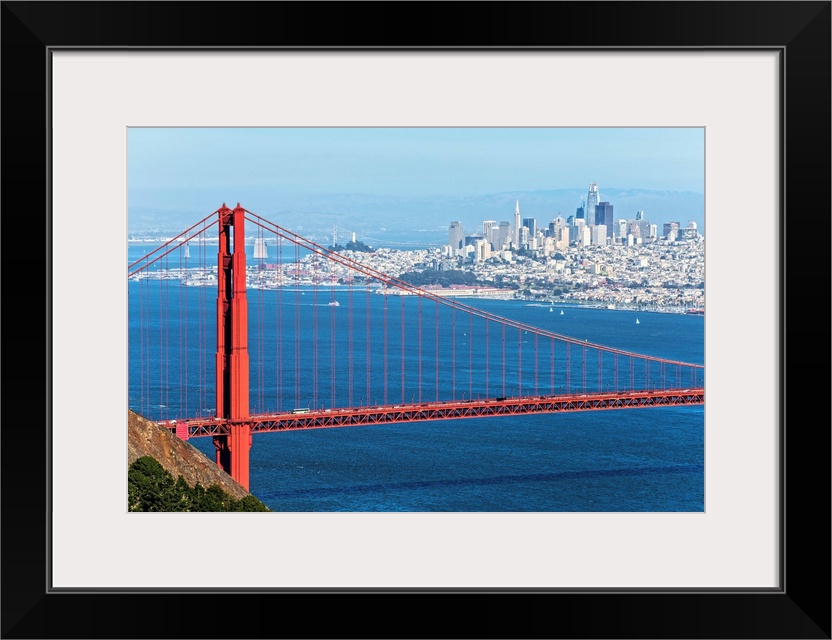 Photograph of the Golden Gate Bridge with San Francisco's skyscrapers in the background.