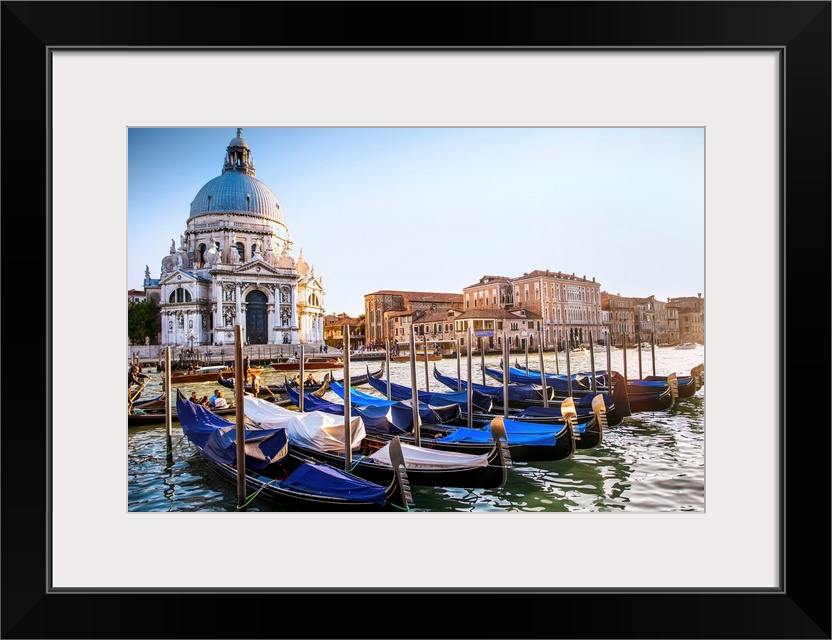 Photograph of gondolas lined up in a row in front of Santa Maria della Salute, Venice, Italy, Europe