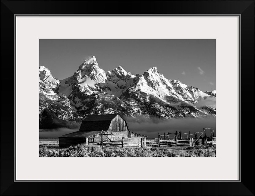 The John Moulton barn sits against a picturesque landscape of the Teton mountain range in Wyoming.