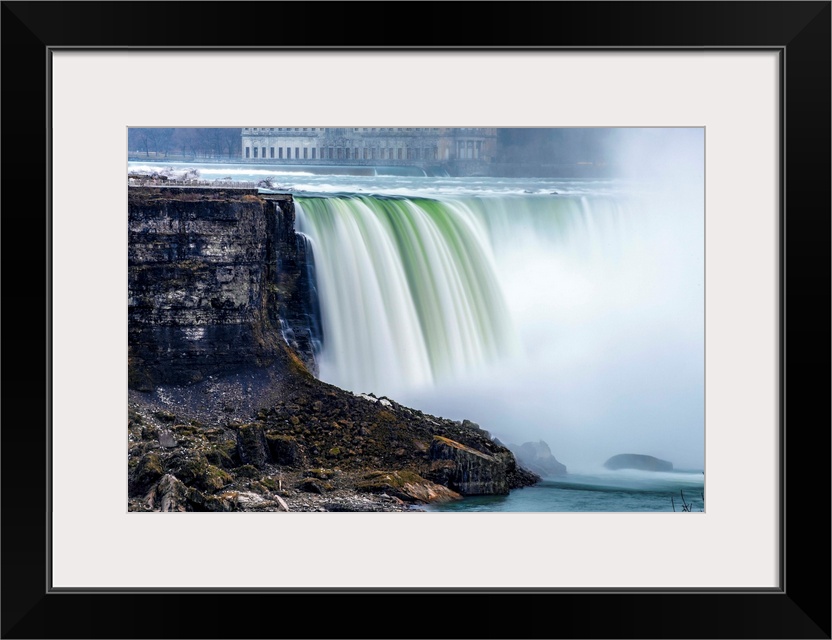 View of Horseshoe Falls at Niagara Falls with former Toronto power generating station in the background.