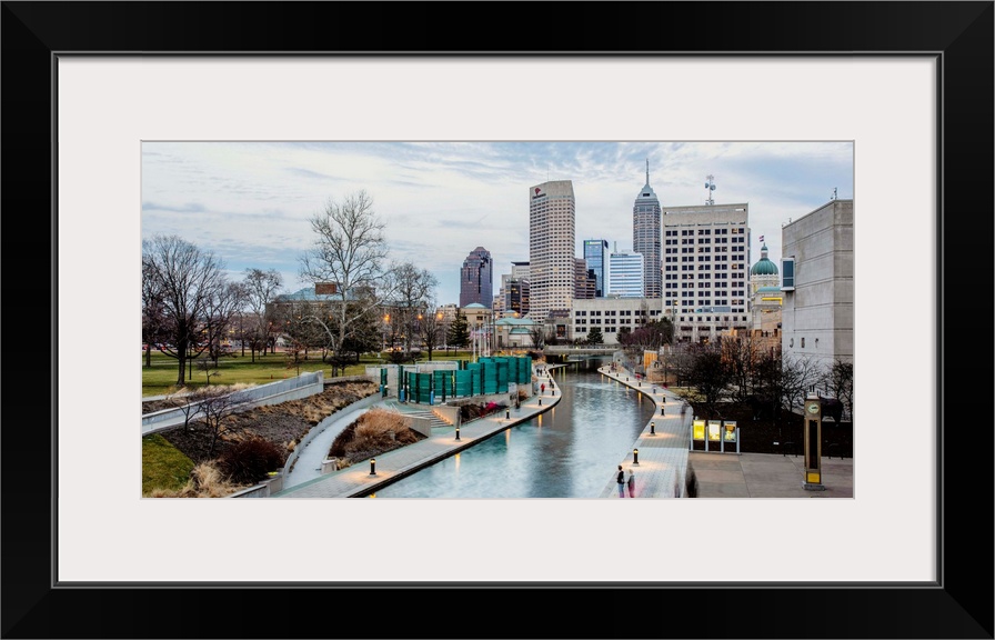 Photo of the Indianapolis city skyline reflecting onto the Indiana Central Canal.