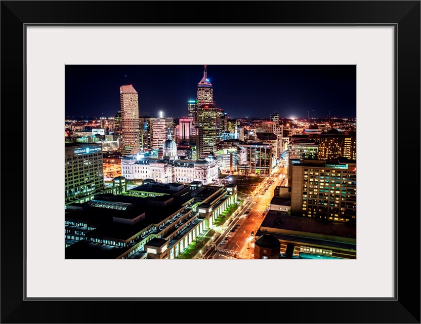 Skyscrapers illuminated at night with busy streets in Indianapolis, Indiana.