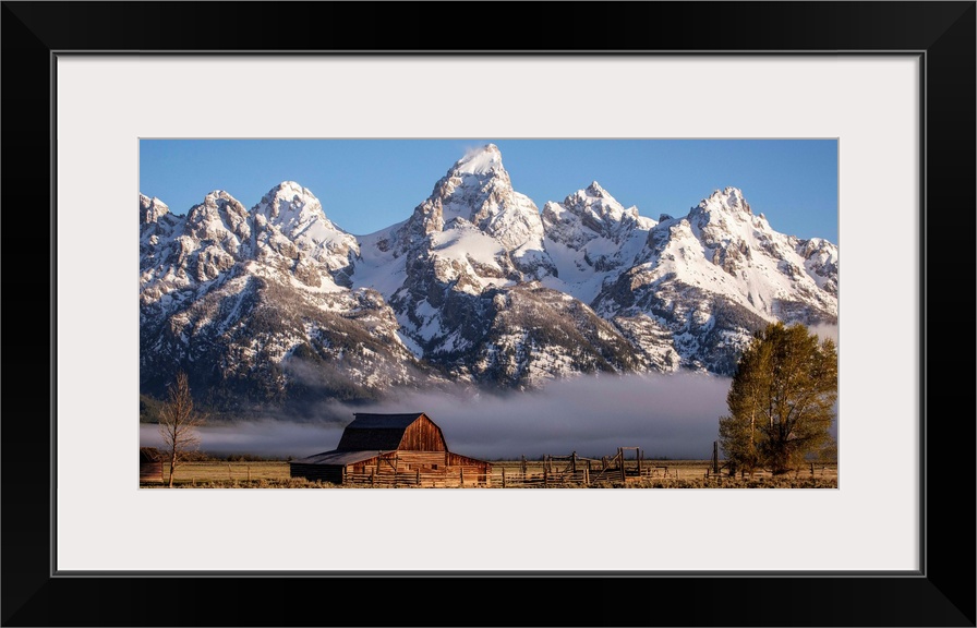 View of the John Moulton Barn with Middle Teton, Grand Teton and Mount Owen in the background. Grand Teton National Park, ...