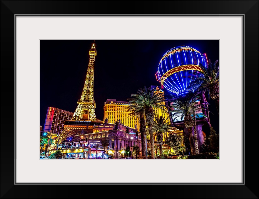 Evening photograph of the Las Vegas strip with the Eiffel Tower and hot air balloon.