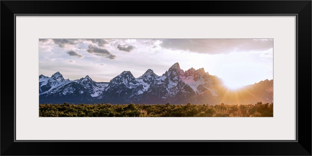 Panoramic view of the sun rising over Teton mountains in Wyoming.