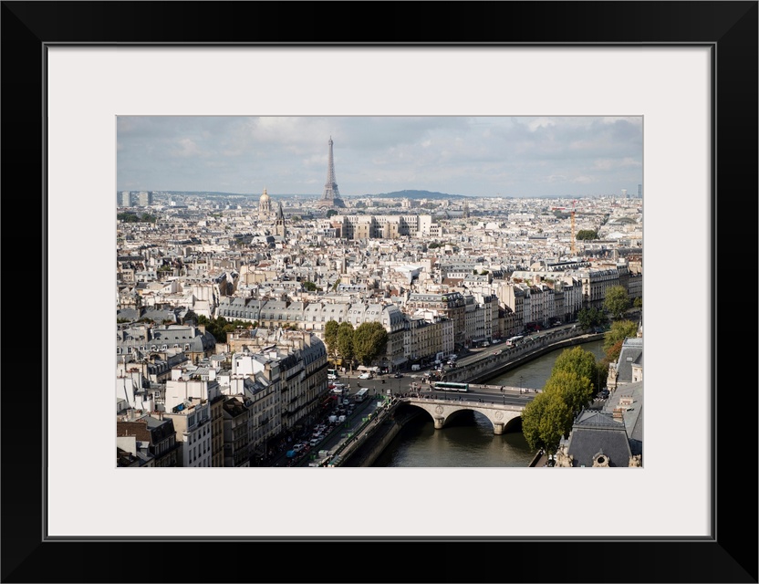 Photograph of a Paris Cityscape with the Eiffel Tower towering over the city.