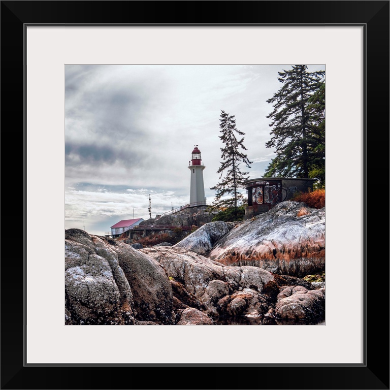 View of Point Atkinson Lighthouse and rocky shore in Vancouver, British Columbia, Canada.
