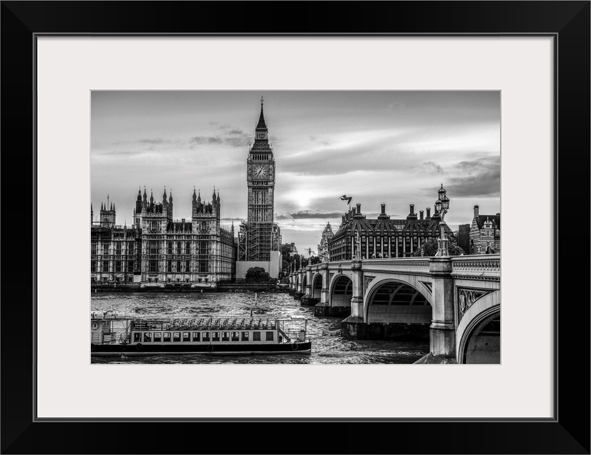 Photograph of a river boat on the River Thames about to go under the Westminster Bridge with Big Ben in the background.