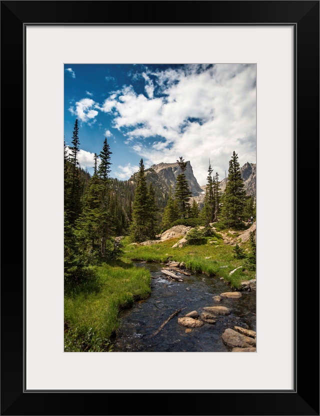 Landscape photograph of a stream going through Rocky Mountain National Park on a beautiful day.
