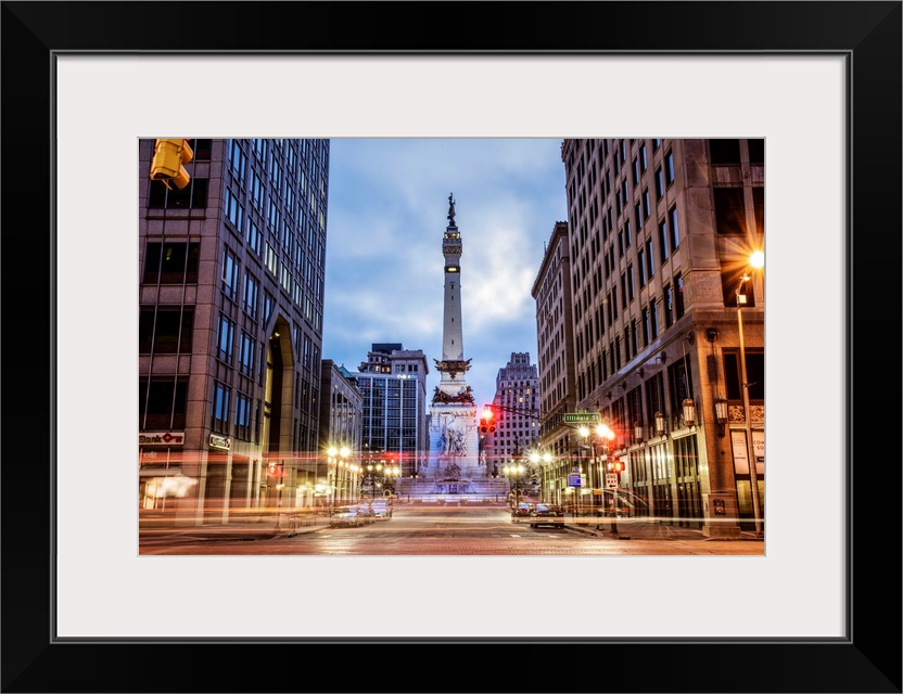 The Soldiers and Sailors Monument in the evening with lights from passing traffic in Indianapolis, Indiana.