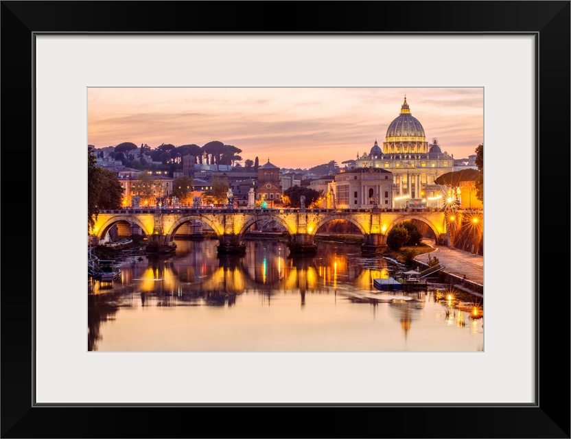 A view of St. Peter's Basilica in the Vatican and the Ponte Sant'Angelo  spanning across the river Tober in Rome, Italy at...