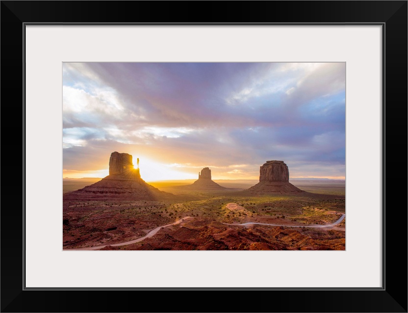 Sunrise at the Mittens and Merrick Buttes in Monument Valley, Arizona.