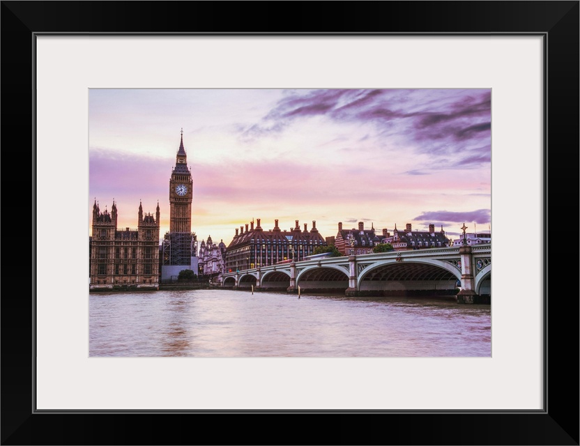 Photograph of Big Ben and the Westminster Bridge with a pink and purple sunset.