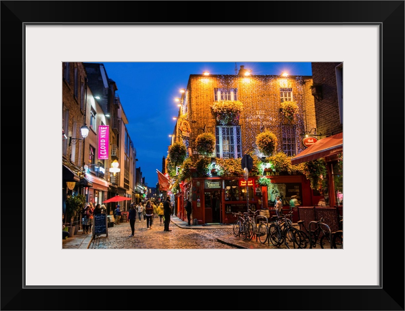 Photograph of Temple Bar, a busy riverside neighborhood in Dublin, Ireland, at night.