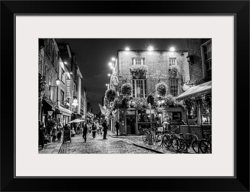 Photograph of Temple Bar, a busy riverside neighborhood in Dublin, Ireland, at night.