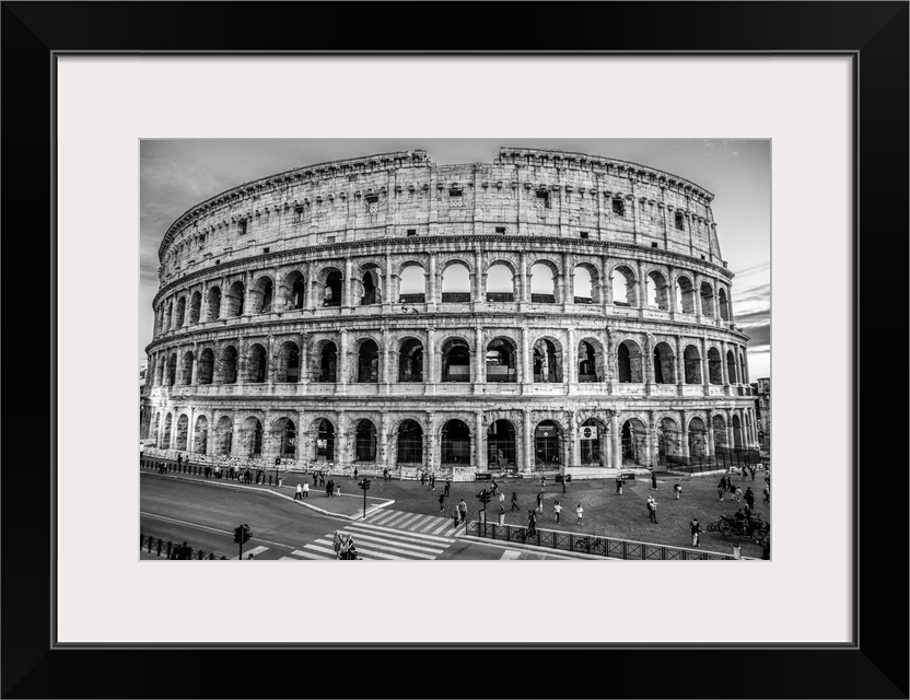 Photograph of the Colosseum lit up at dusk.