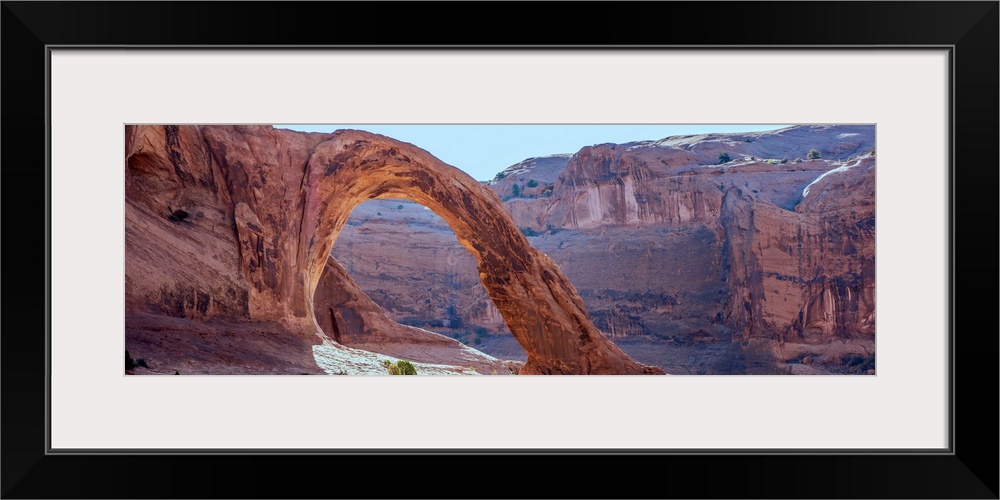 Sunlight shining on the desert landscape around the Corona Arch, Arches National Park, Utah.