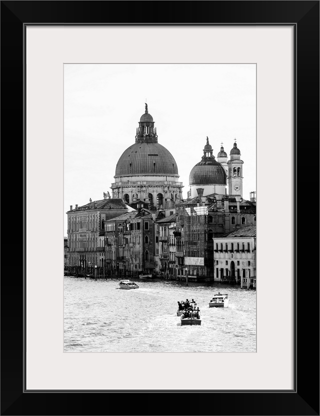 Landscape photograph of gondolas and boats on the Grand Canal with Santa Maria della Salute in the background.