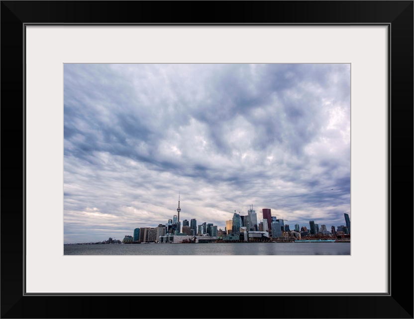 Toronto city skyline under dramatic clouds, Ontario, Canada.