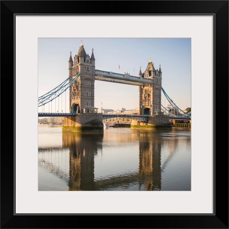 Square photograph of Tower Bridge reflecting into the River Thames in London, England, UK.