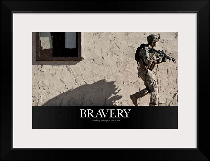 A soldier is photographed walking in front of a concrete wall with his weapon up and the word "Bravery" written below.