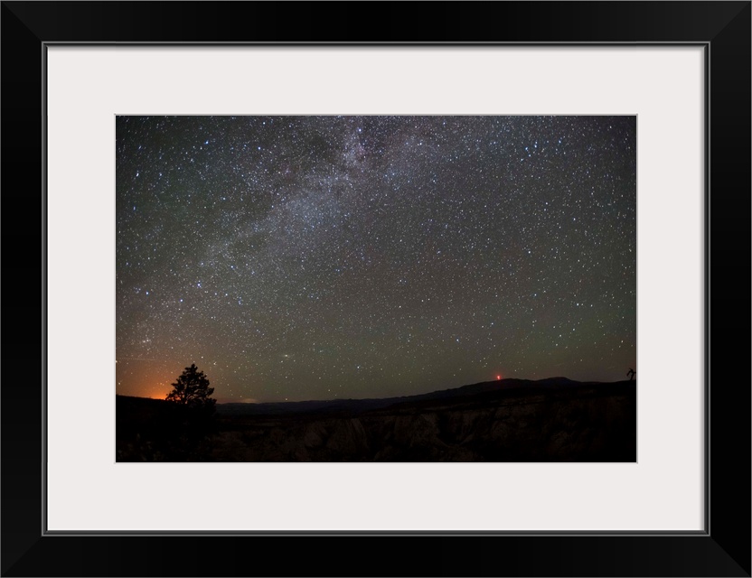 Silhouette photograph of Zion National Park at night time with a starry sky above.