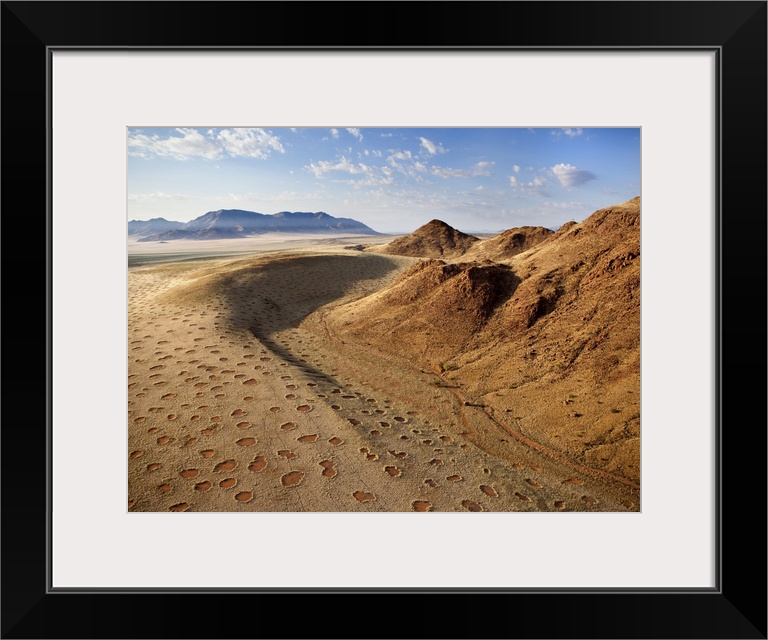 Aerial view from hot air balloon over magnificent desert landscape of sand dunes, mountains and Fairy Circles, Namib Rand ...