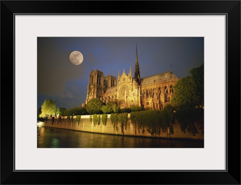 Notre Dame Cathedral at night, with moon rising above, Paris, France, Europe